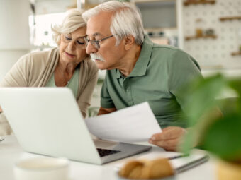 Senior couple analyzing their savings while going through home f